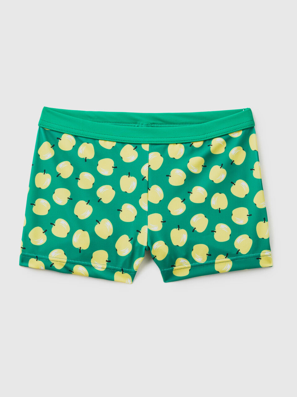 Green swim trunks with apple pattern